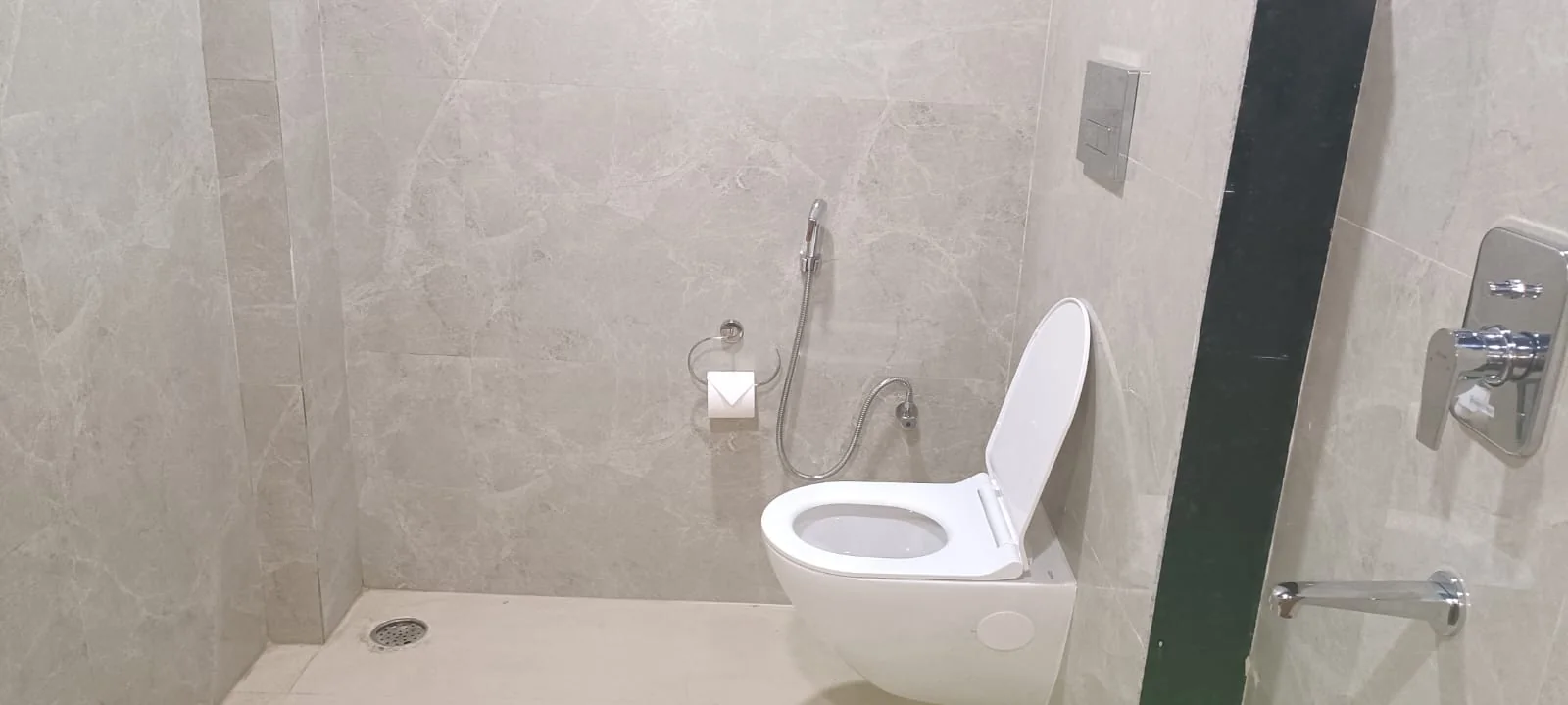 Modern tiled bathroom vanity at Satyvan Hotel equipped with clean fixtures, a basin, and complimentary guest toiletries